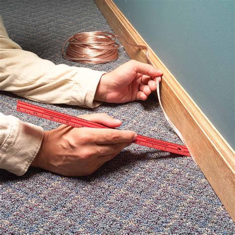 how to hide wire under carpet